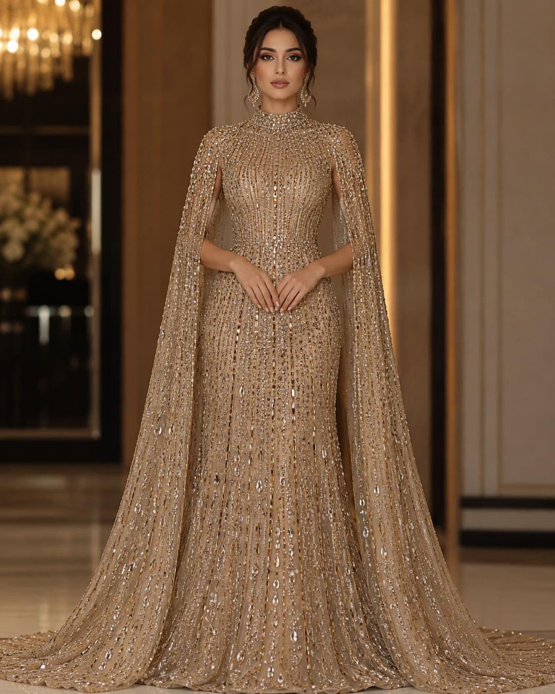 Woman wearing a shimmering gold sequined evening gown with a long, elegant cape.