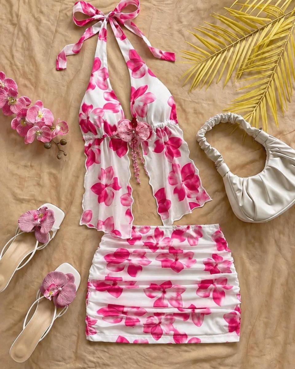 A white and pink floral print summer two-piece set with matching sandals and a white handbag.
