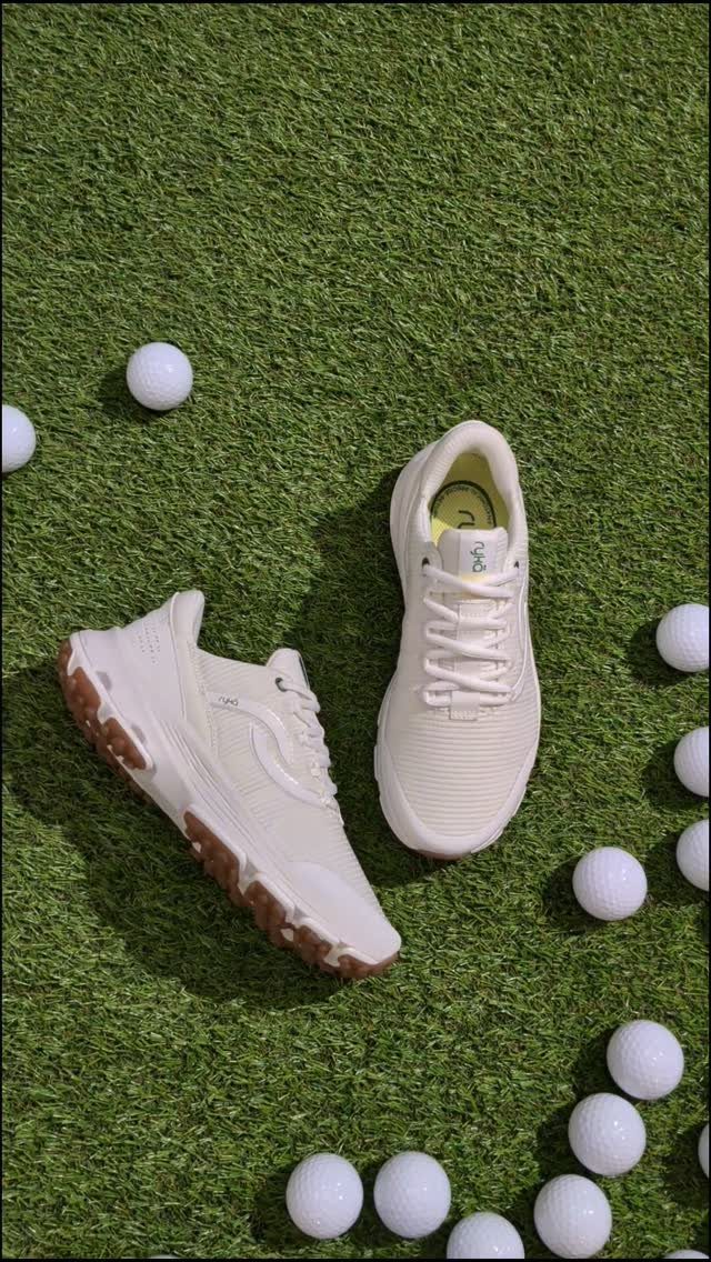 Cream athletic shoes and white golf balls scattered on green artificial turf.