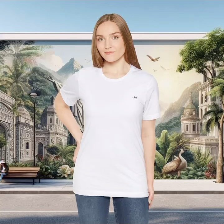 Woman wearing a plain white t-shirt and blue jeans standing before a tropical mural.