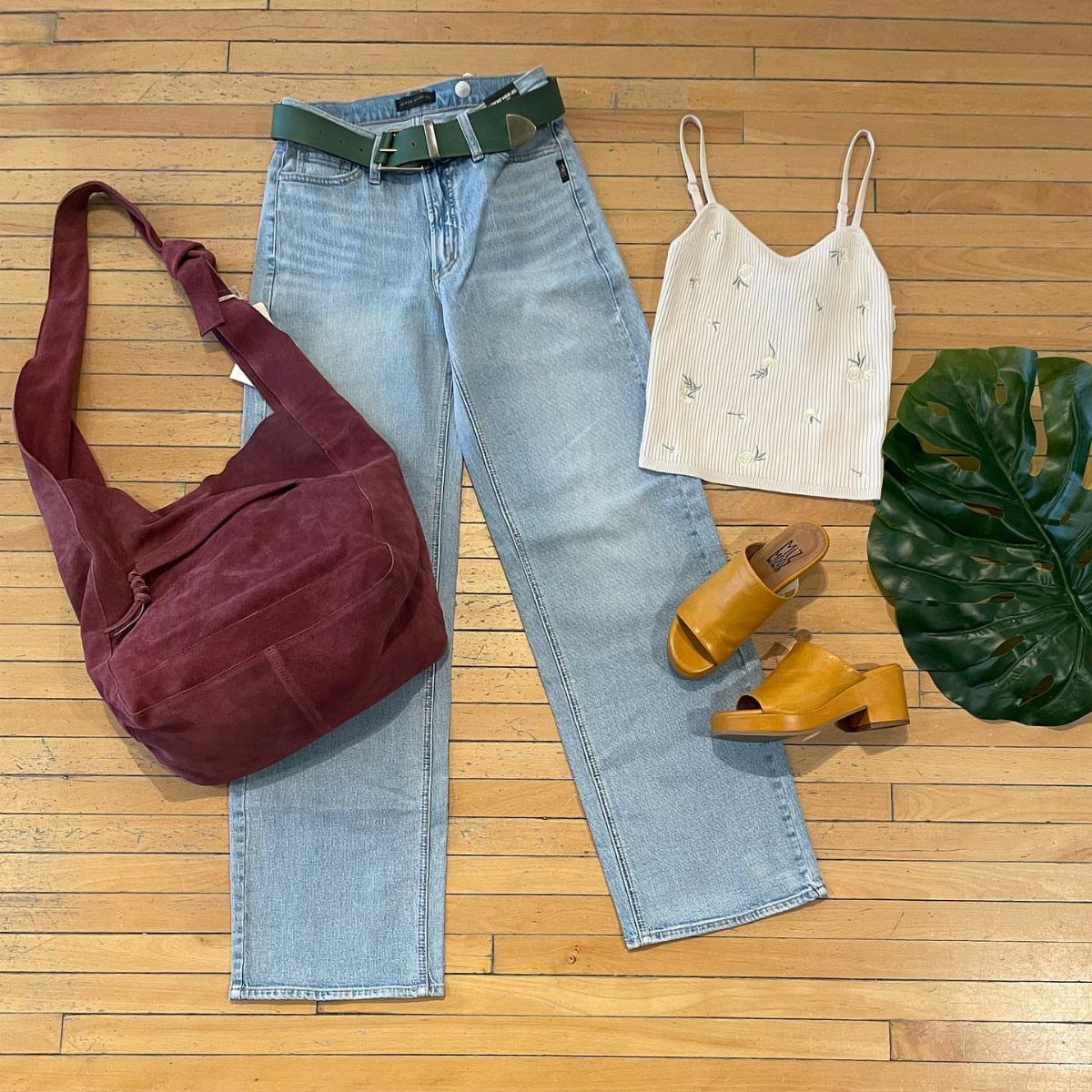 Light blue wide-leg jeans paired with tan platform mules, a burgundy bag, and a white top.