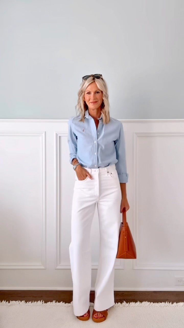 Blonde woman wearing a light blue shirt and white wide-leg denim jeans.