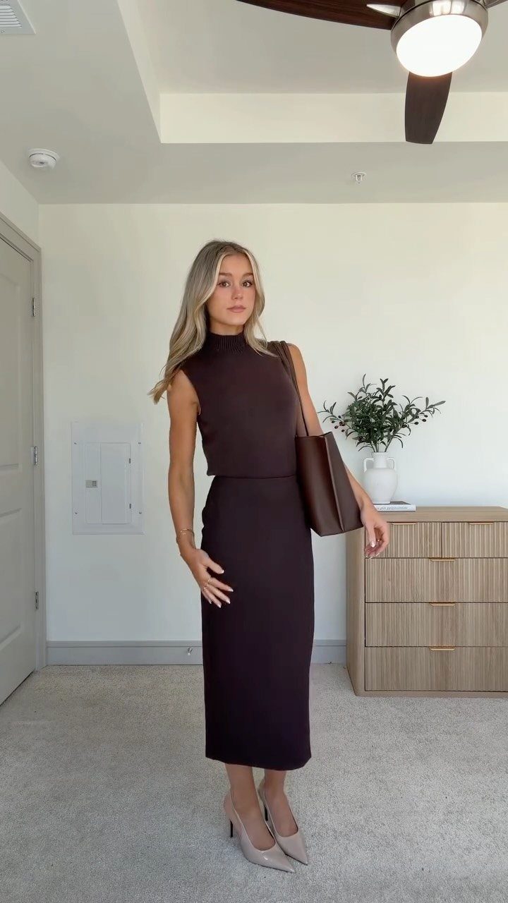 A woman wearing a dark brown sleeveless knit top and a matching pencil skirt with beige heels.