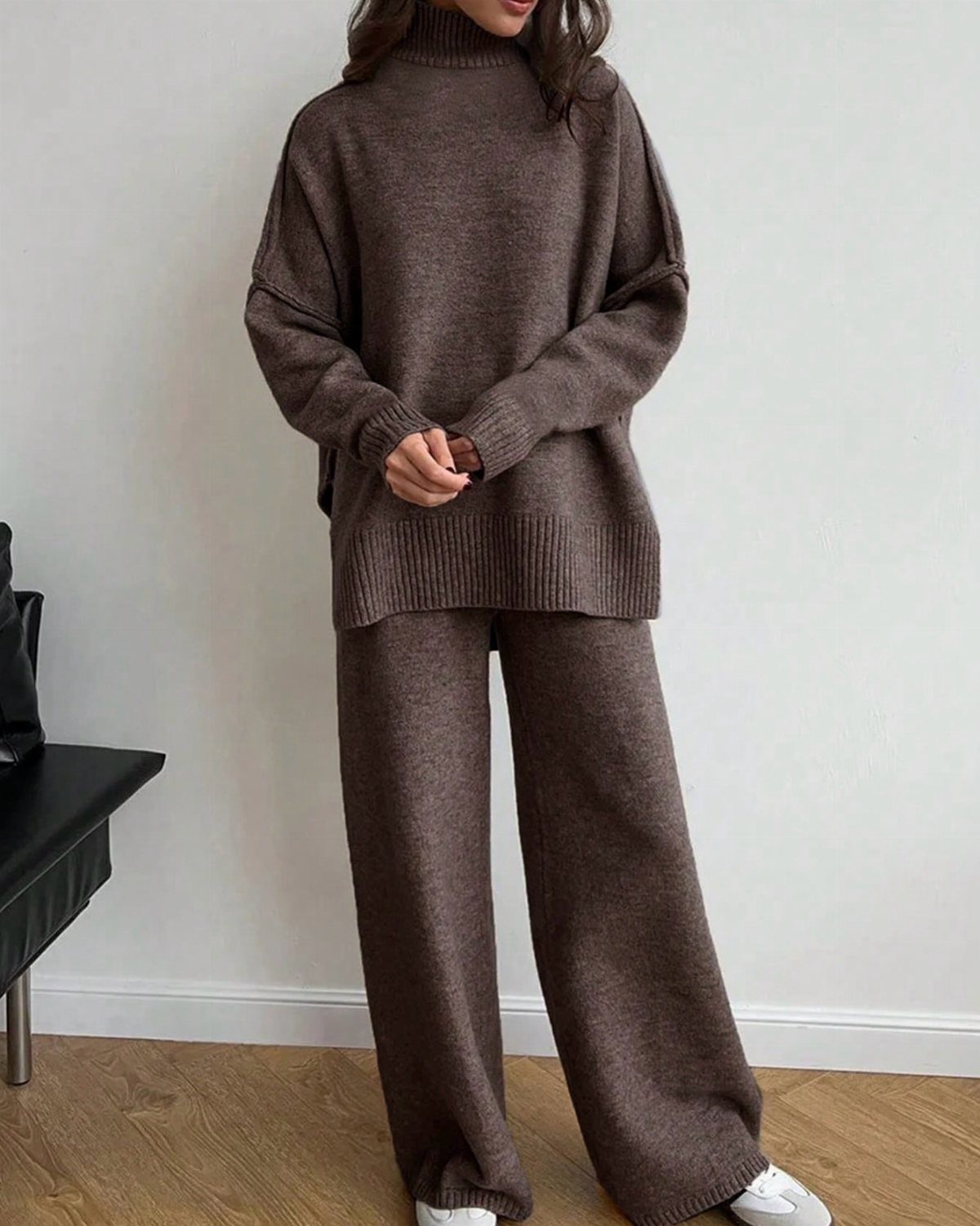 Person wearing a matching brown oversized turtleneck sweater and wide-leg knit trousers.